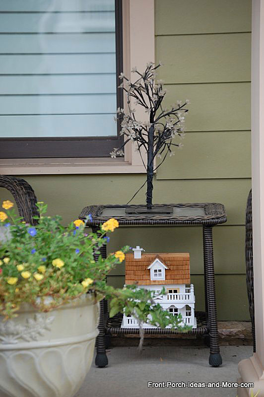 Illumination tree on wicker table on front porch