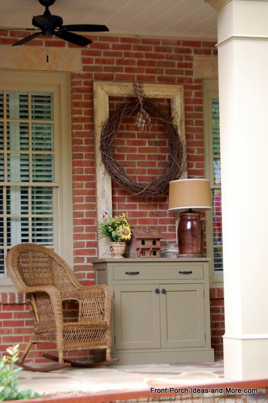 front porch cabinet with outdoor lamp and birdhouse