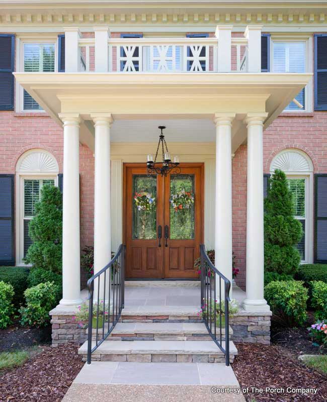 brick home beautifully designed portico with widows walk