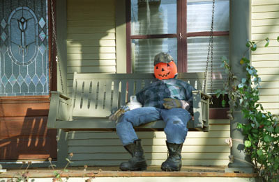 Pumpkin man on porch swing
