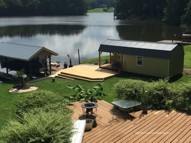 shed with porch beside lake by Liberty Sheds