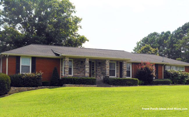 shed porch roof on ranch home with stone columns