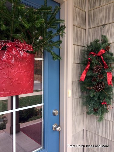 Fresh greenery and red bows dress up our front door
