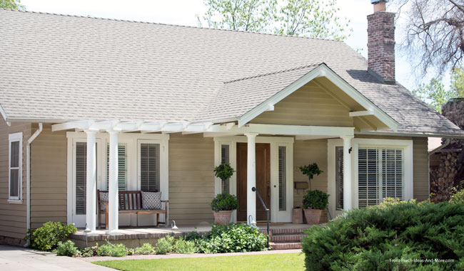 cottage style home with steep gable porch roof