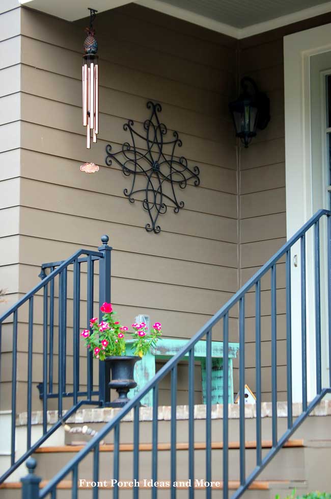 Pretty wall art on a small front porch