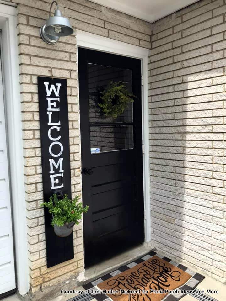 joni's door next to her garage is decorated with a black and white theme and pops of color