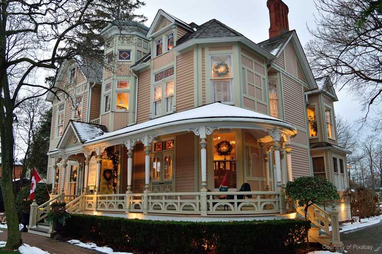Beautiful Victorian home with wreaths in the windows