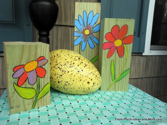 Simple spring flowers painted on scraps of wood.